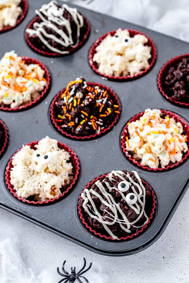 Up close image of the Halloween popcorn balls in a muffin tin.