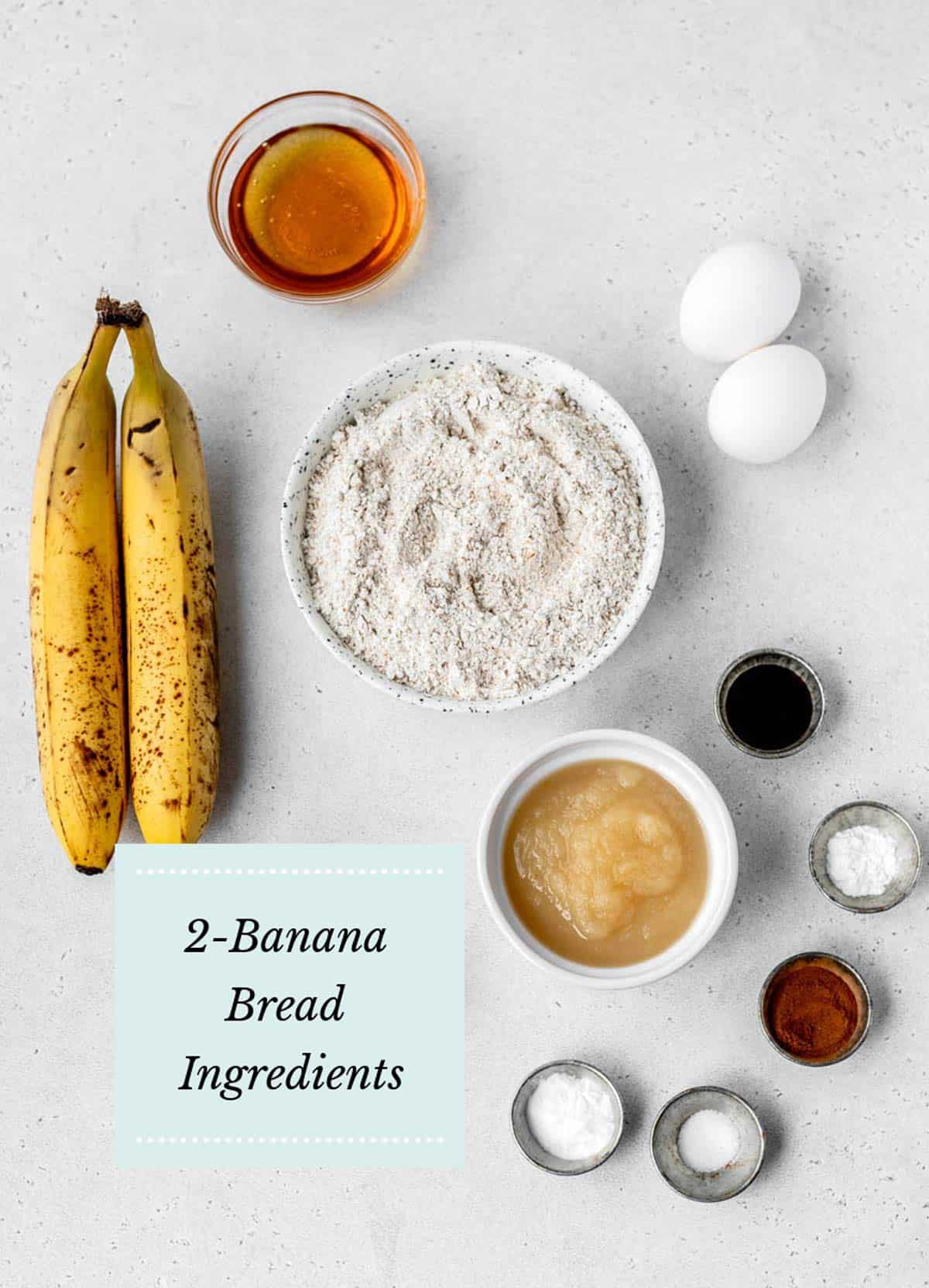 Two banana bread ingredients, including  bananas, flour, honey, applesauce, cinnamon and two eggs.