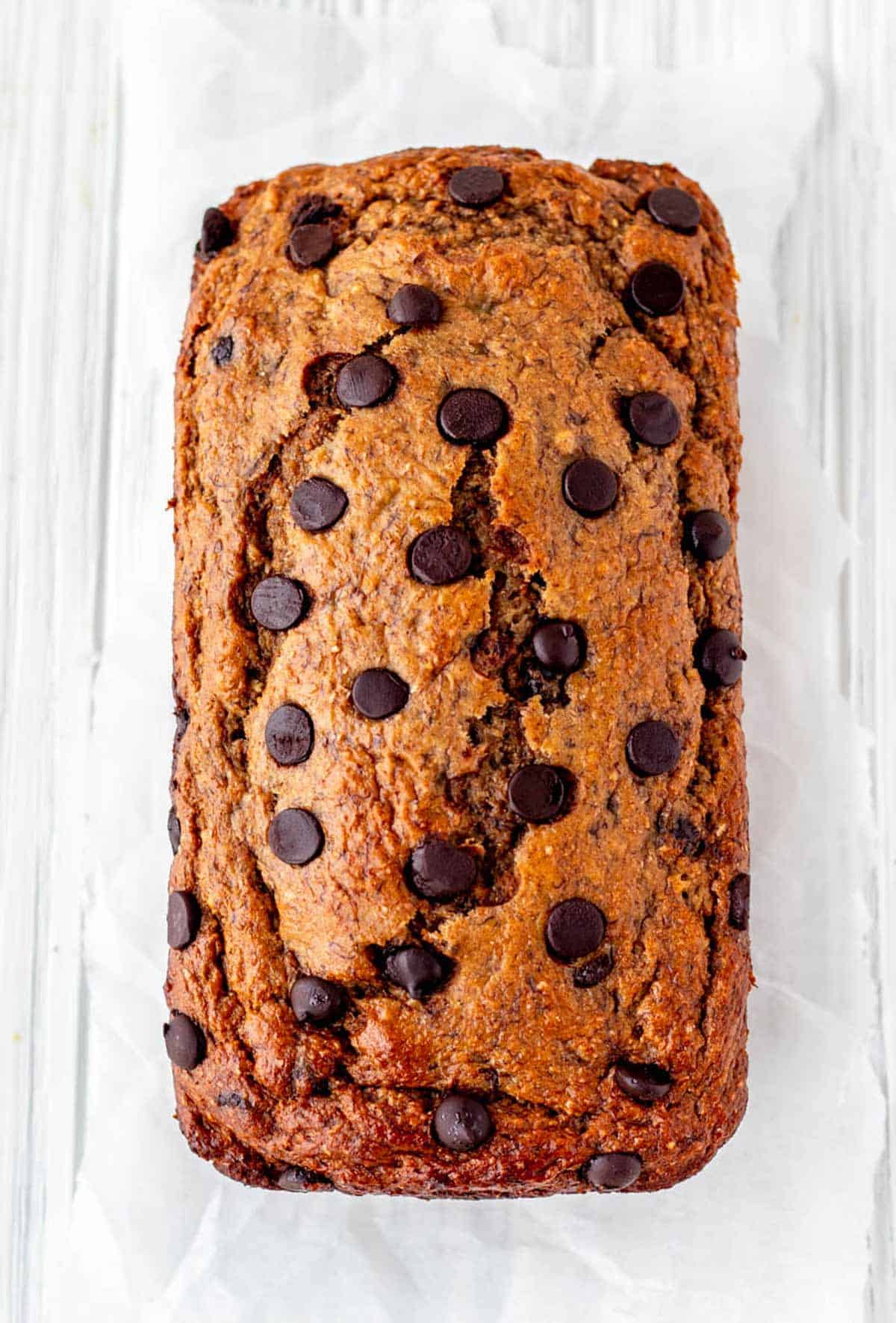A baked loaf of 2 banana bread with dark chocolate chips.