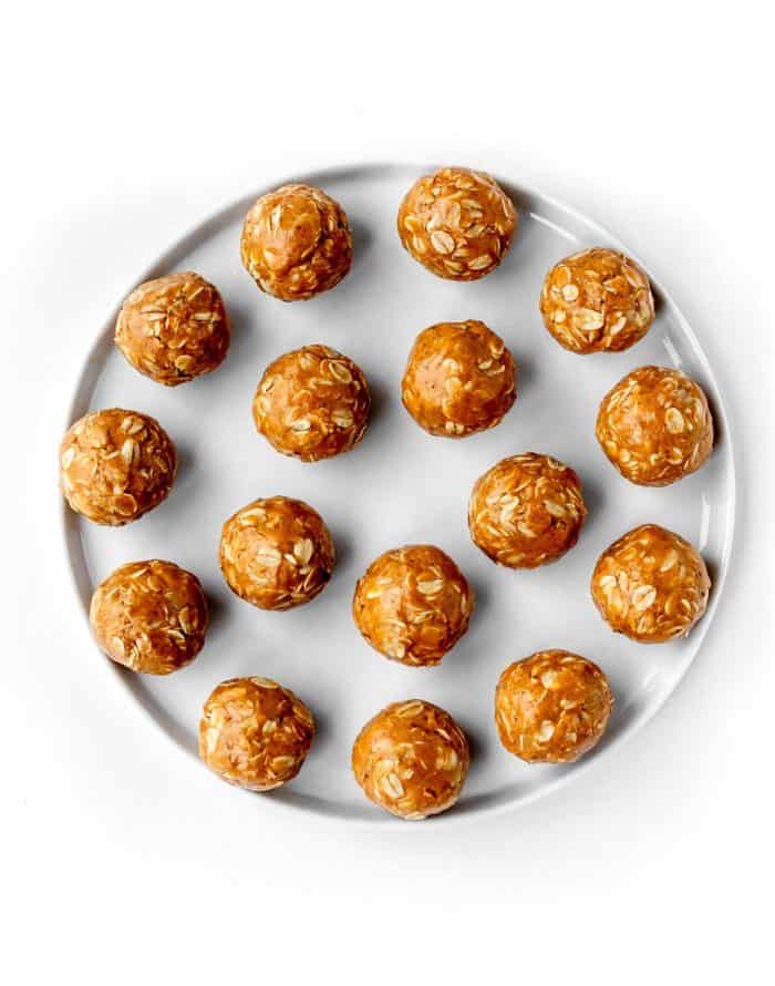 A batch of no-bake peanut butter oatmeal balls on a white plate.