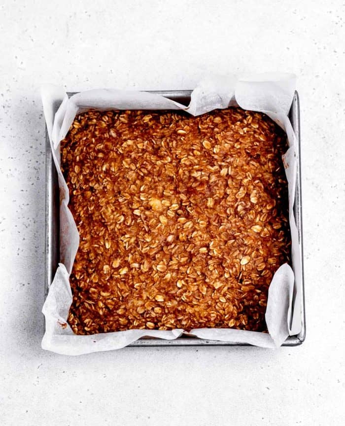 The peanut butter banana oatmeal mixture baked in a square pan.