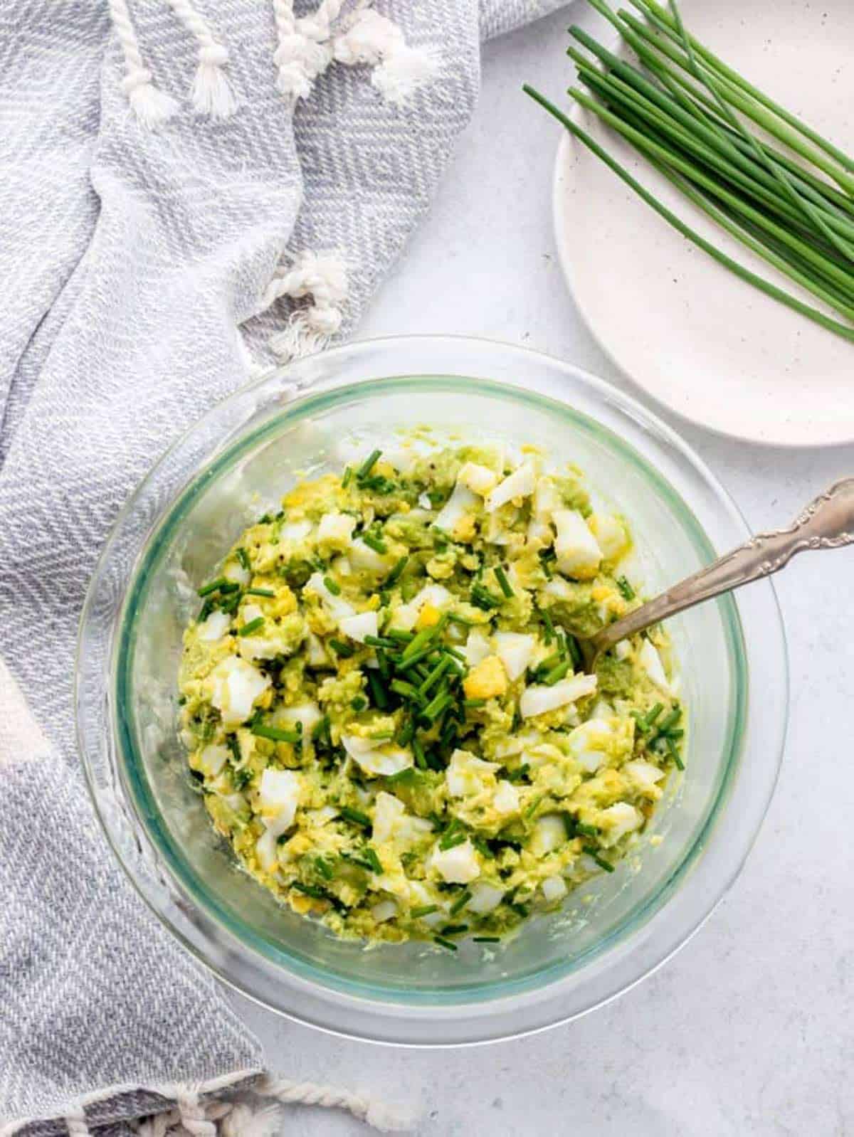 Low carb egg salad recipe mixed together in a bowl with a spoon.