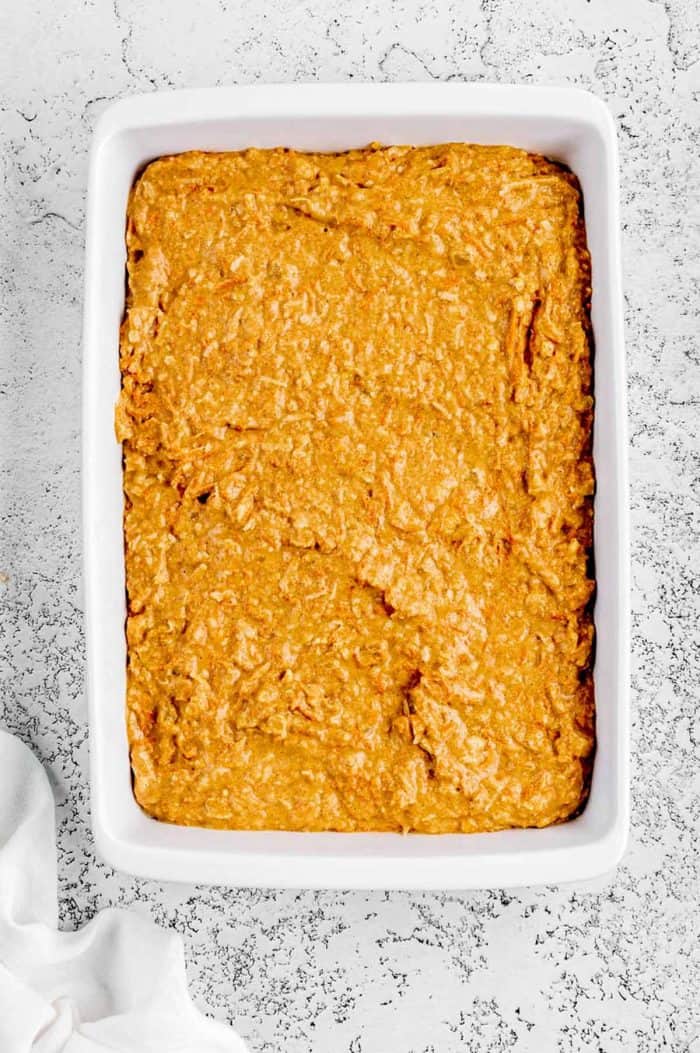 The carrot cake batter in a large white baking pan.