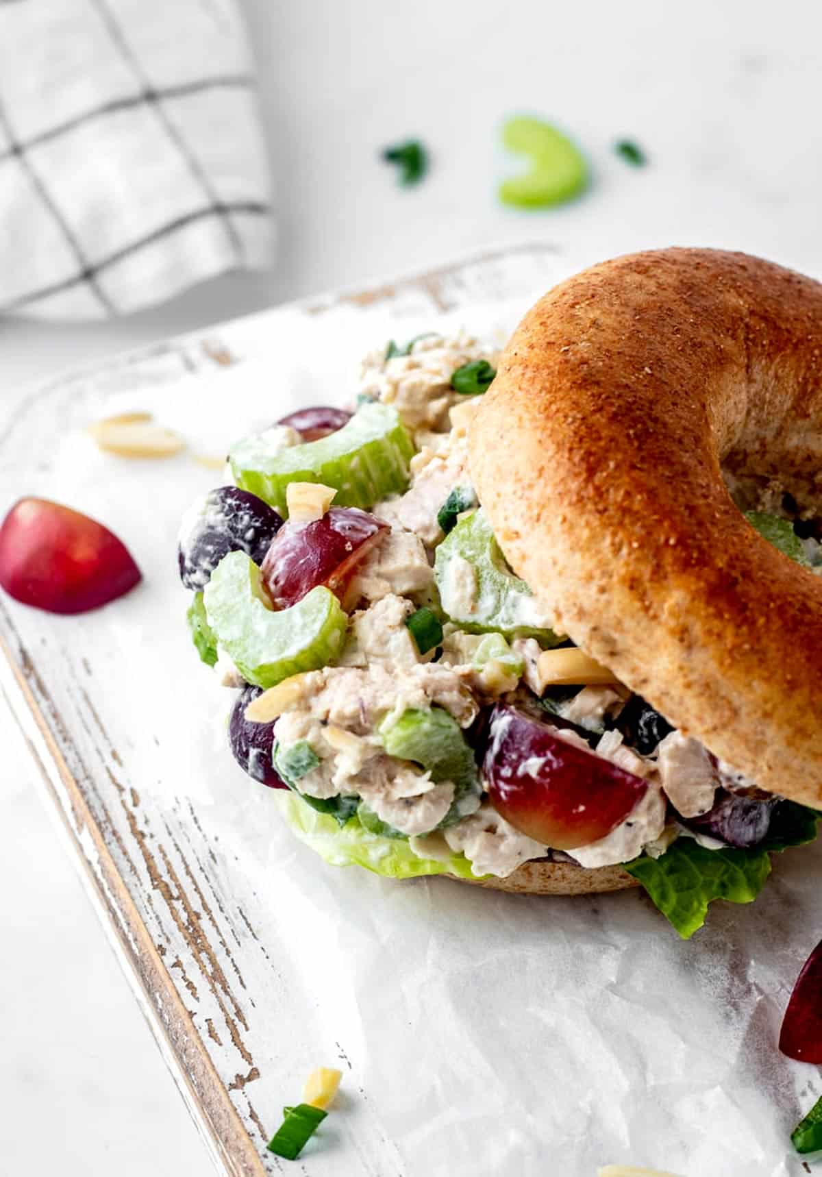 The yogurt chicken salad on a bagel with grapes and almonds.