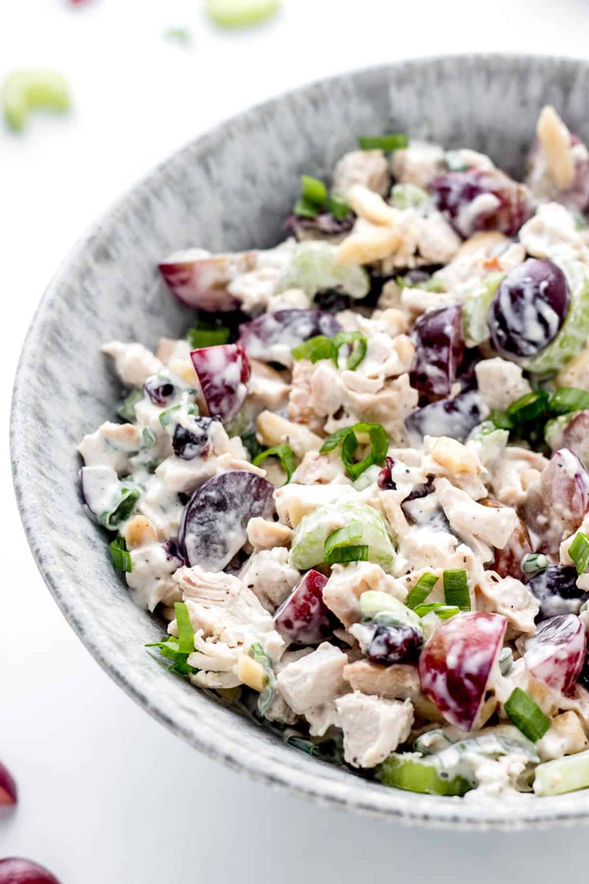 Creamy chicken salad in a bowl with grapes and almonds.